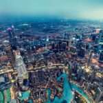 Dubai UAE aerial rooftop view from Burj Khalifa at night. Famous fountains and downtown